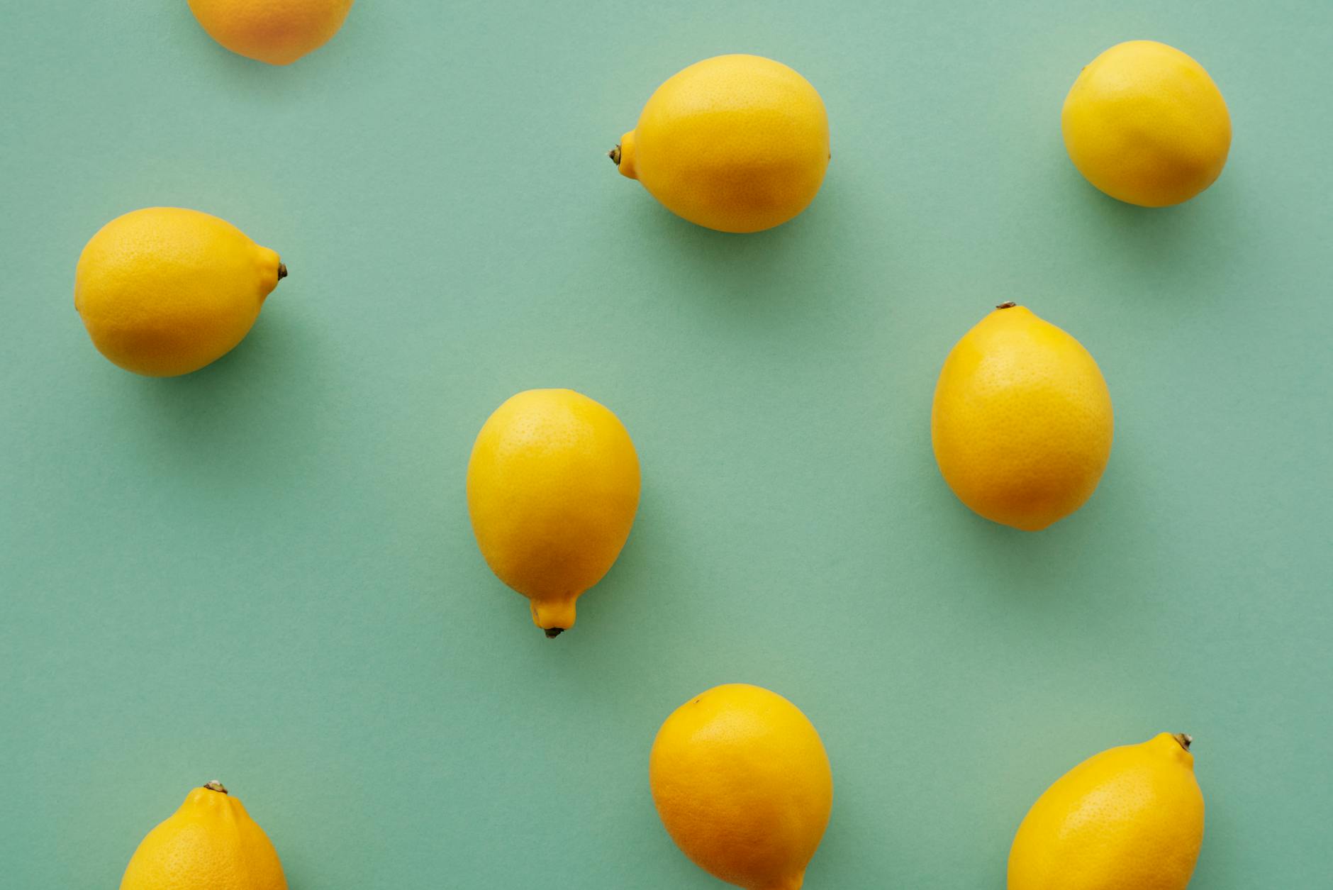 Fresh lemons on a pastel green background, symbolizing fresh approaches to overcoming pleasure anxiety