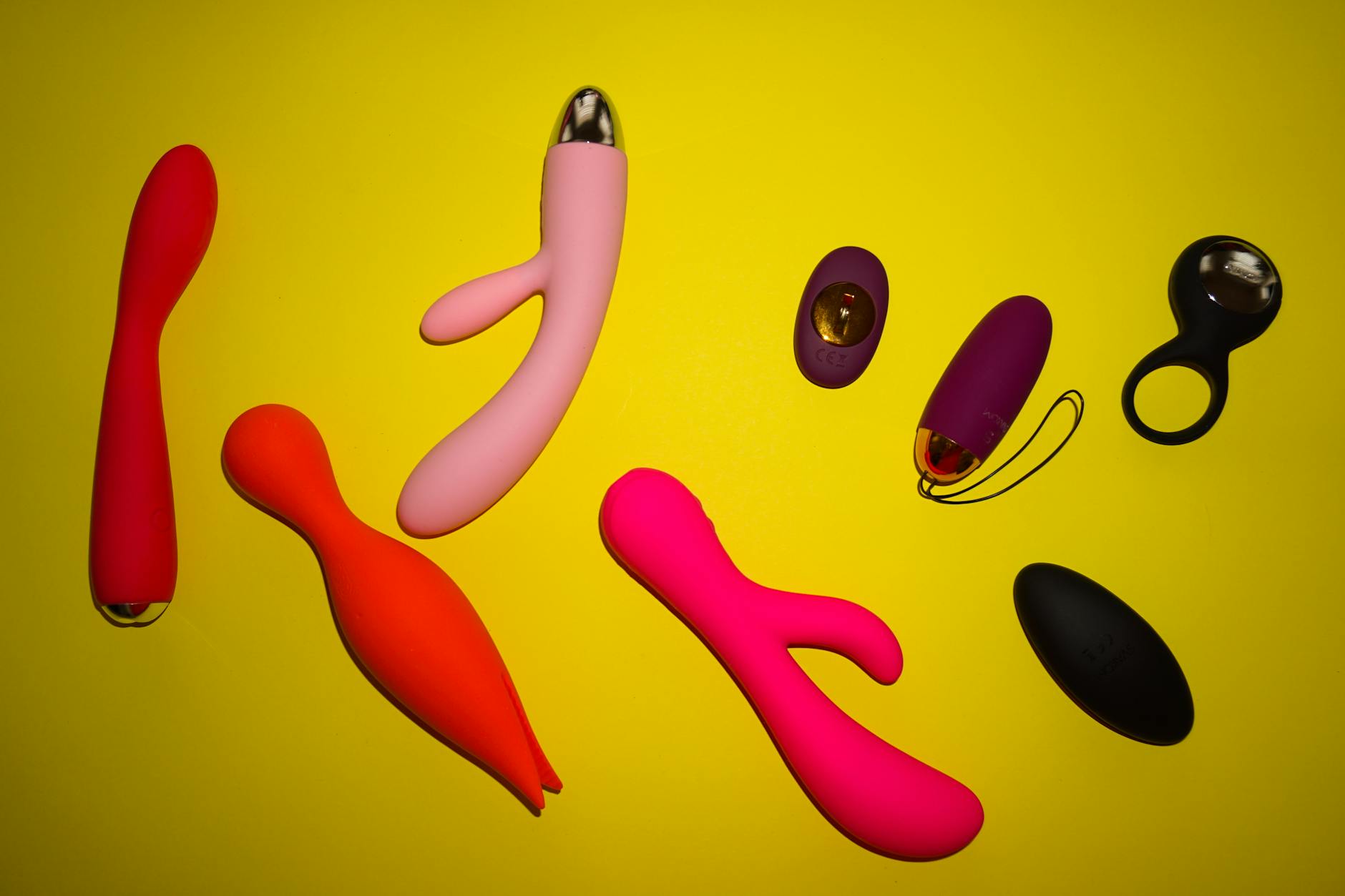 A blue silicone clitoral vibrator held gently in hand, symbolizing self-care and intimate recovery