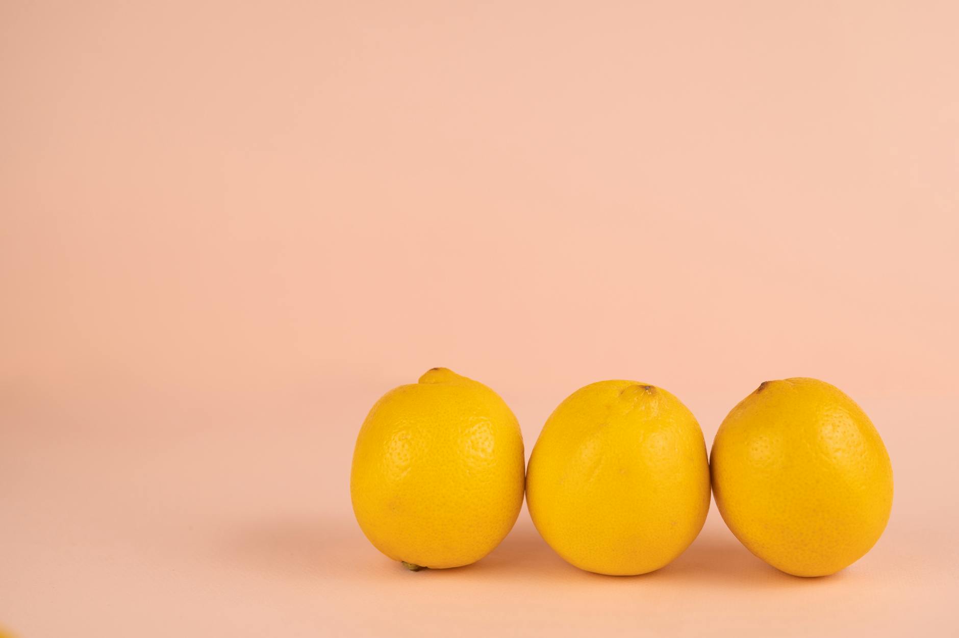 Fresh lemons arranged on a soft pastel background, symbolizing change and renewal